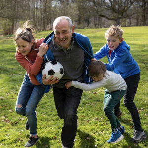 A father and children playing football together